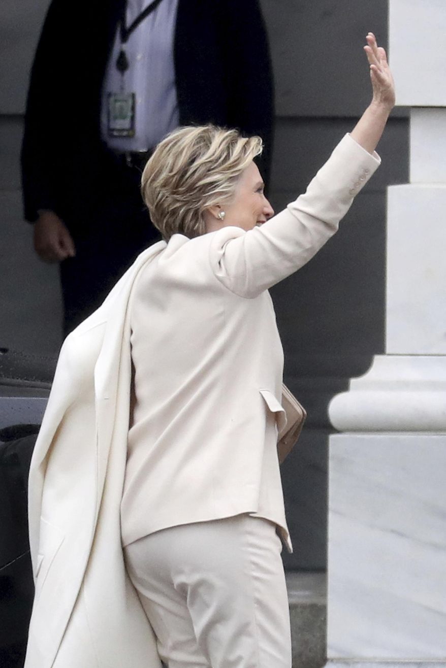 Hillary Clinton waves as she arrives on Capitol Hill in Washington, Friday, Jan. 20, 2017, for the presidential inauguration of Donald Trump becomes the 45th president of the United States. (Rob Carr via AP, Pool)