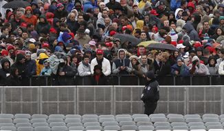 A Capitol Hill police officer watches the crowd before the swearing in of Donald Trump as the 45th president of the United States during the 58th Presidential Inauguration at the U.S. Capitol in Washington. Friday, Jan. 20, 2017 (AP Photo/Andrew Harnik)