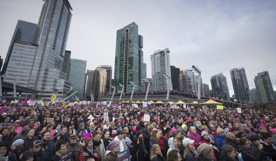 Thousands of people gather for a women&#39;s march and protest against U.S. President Donald Trump, in Vancouver, British Columbia on Saturday Jan. 21, 2017. Protests are being held across Canada today in support of the Women&#39;s March on Washington.   (Darryl Dyck/The Canadian Press via AP)