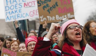 Protesters cheer at the Women&#39;s March on Washington during the first full day of Donald Trump&#39;s presidency, Saturday, Jan. 21, 2017 in Washington. (AP Photo/John Minchillo)