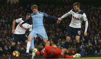 Manchester City&#39;s Kevin De Bruyne, left shoots past a diving Tottenham Hotspur&#39;s goalkeeper Hugo Lloris to score his sides second goal of the game during the English Premier League soccer match between Manchester City and Tottenham Hotspur at the Etihad stadium in Manchester, England, Saturday, Jan., 21, 2017. (AP Photo/Dave Thompson)