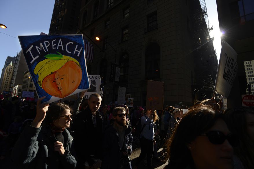 Protesters protest newly inaugurated President Donald Trump during a women's march Saturday, Jan. 21, 2017, in Chicago. (AP Photo/Paul Beaty)