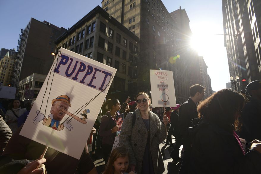 Protesters protest newly inaugurated President Donald Trump during a women's march Saturday, Jan. 21, 2017, in Chicago. (AP Photo/Paul Beaty)