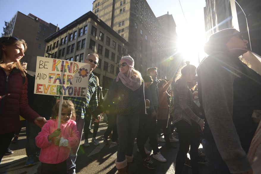 Protesters protest newly inaugurated President Donald Trump during a women's march Saturday, Jan. 21, 2017, in Chicago. (AP Photo/Paul Beaty)