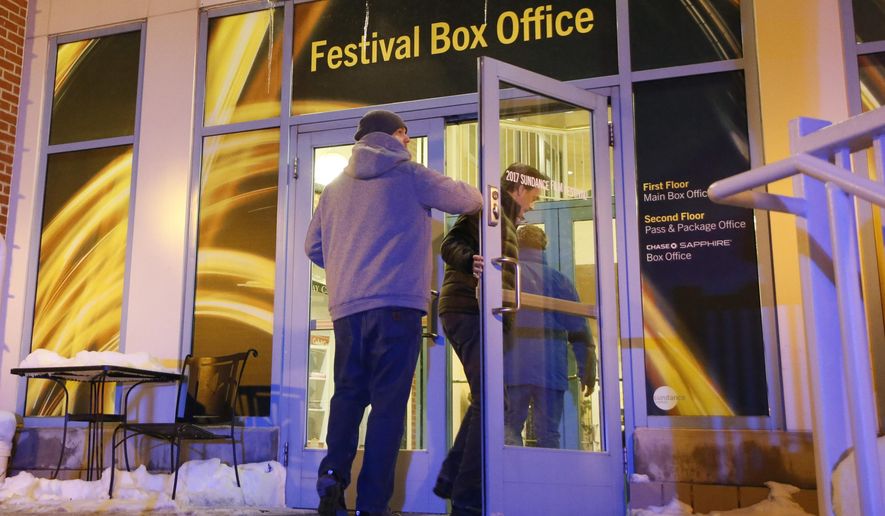 People enter a door leading to the Festival Box Office during the 2017 Sundance Film Festival on Saturday, Jan. 21, 2017, in Park City, Utah. Representatives for the Sundance Film Festival say that their network systems were subject to a cyberattack that caused its box offices to shut down briefly Saturday afternoon. (Photo by Danny Moloshok/Invision/AP)