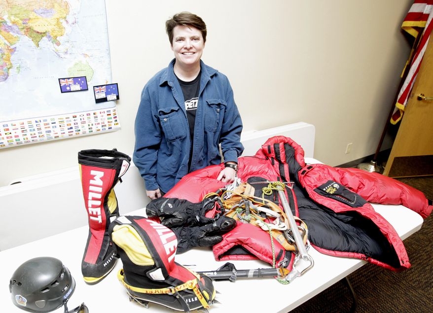 ADVANCE FOR USE SATURDAY, JAN. 21 - In this Monday, Jan. 9, 2017 photo, Jen Loeb poses with climbing gear at the Jesup Public Library in Jesup, Iowa. Last year Loeb, 40, became the first Iowa woman to summit Mount Everest, the world's tallest peak at 29,029 feet above sea level. (Tiffany Rushing/The Courier via AP)