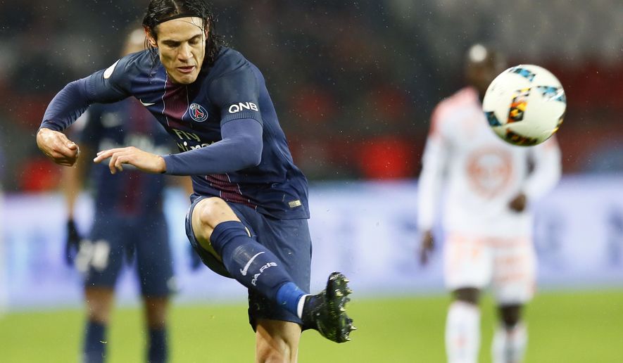 FILE - In this Wednesday, Dec. 21, 2016 file photo, PSG&#39;s Edinson Cavani kicks the ball during their French League One soccer match between PSG and Lorient at the Parc des Princes stadium in Paris, France. Cavani punished Nantes for missing clear chances by scoring both goals as Paris Saint-Germain won 2-0 away from home to move one point behind leader Nice. (AP Photo/Francois Mori, File)