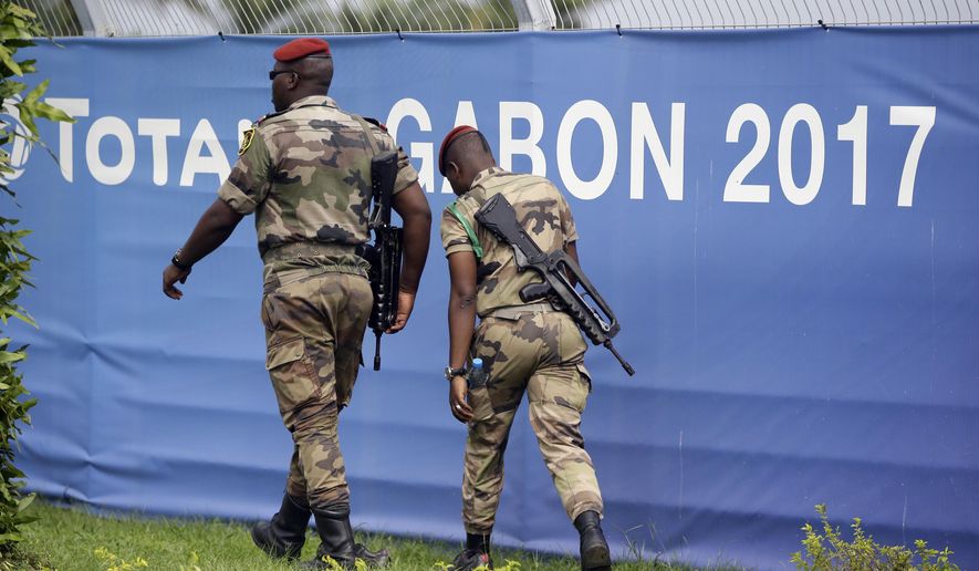 Soldiers patrol during Gabon&#39;s soccer team training session at the Stade de l&#39;Amitie, Libreville, Gabon, Saturday, Jan. 21, 2017, ahead of their African Cup of Nations Group A soccer match against Cameroon. (AP Photo/Sunday Alamba)