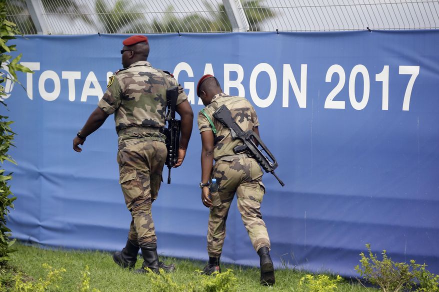 Soldiers patrol during Gabon&#39;s soccer team training session at the Stade de l&#39;Amitie, Libreville, Gabon, Saturday, Jan. 21, 2017, ahead of their African Cup of Nations Group A soccer match against Cameroon. (AP Photo/Sunday Alamba)