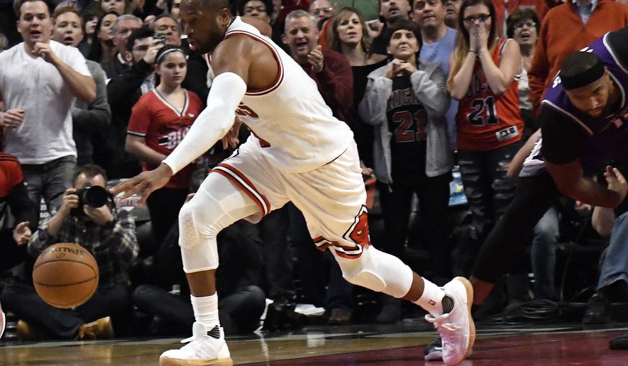 Chicago Bulls guard Dwyane Wade (3) steals the ball against the Sacramento Kings during the second half of an NBA basketball game in Chicago, Saturday, Jan. 21, 2017. (AP Photo/David Banks)