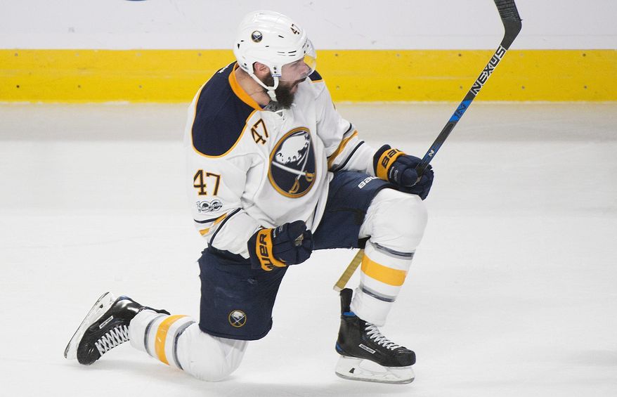 Buffalo Sabres' Zach Bogosian celebrates after scoring during overtime NHL hockey game action against the Montreal Canadiens in Montreal, Saturday, Jan. 21, 2017. (Graham Hughes/The Canadian Press via AP)