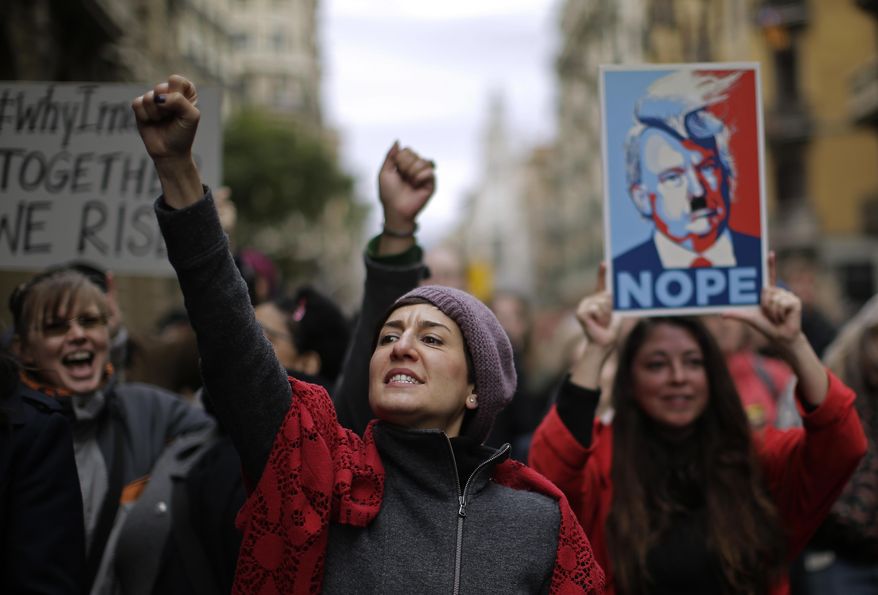 People shouts slogans during the Women's March rally in Barcelona, Spain, Saturday, Jan. 21, 2017. The march was held in solidarity with the Women's March on Washington, advocating women's rights and opposing Donald Trump's presidency. (AP Photo/Manu Fernandez)