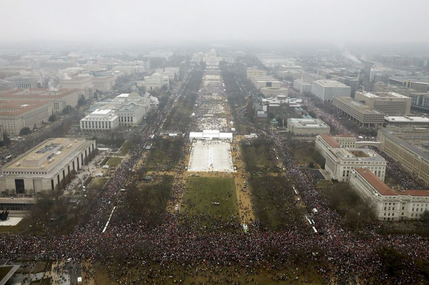 With the U.S. Capitol in the background, a crowd overflows onto the National Mall during the Women's March on Washington during the first full day of Donald Trump's presidency, Saturday, Jan. 21, 2017 in Washington. (Lucas Jackson/Pool Photo via AP)