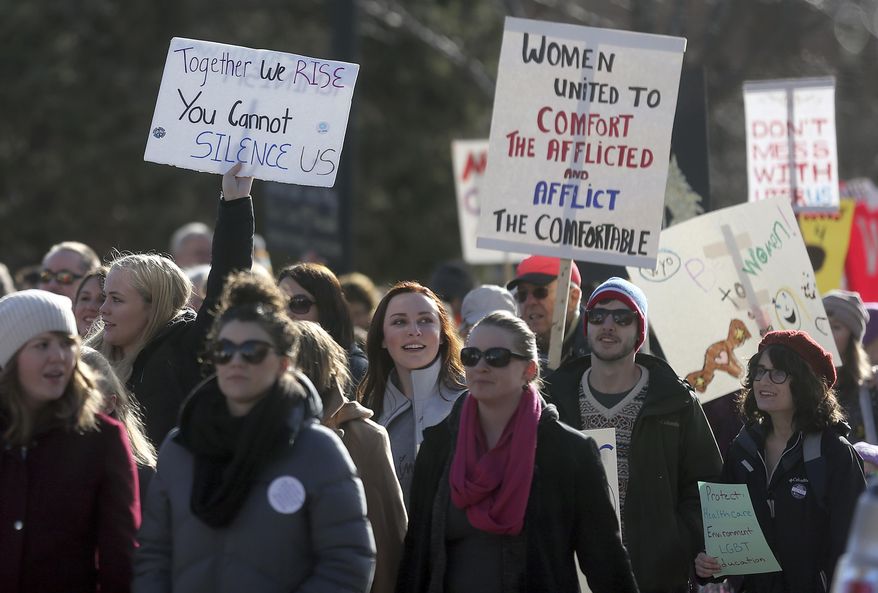 People march up Capitol Avenue during the Women's March Saturday, Jan. 21, 2017, in downtown Cheyenne, Wyo. Around 1,500 and 2,000 people took park in the march to focus on the rights of women and other minorities and disadvantaged groups. (Blaine McCartney /The Wyoming Tribune Eagle via AP)