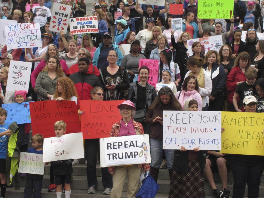 Thousands of women gather for the Stand Up Rally for women and minority rights on Saturday, Jan. 21, 2017, at the Statehouse in Columbia, S.C. Similar rallies were being held across the country to protest President Donald Trump and his administration. (AP Photo/Jeffrey Collins)