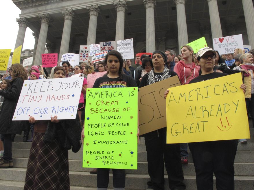 Thousands of women gather for the Stand Up Rally for women and minority rights on Saturday, Jan. 21, 2017, at the Statehouse in Columbia, S.C. Similar rallies were being held across the country to protest President Donald Trump and his administration. (AP Photo/Jeffrey Collins)