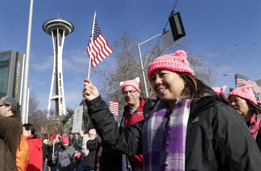 Marchers numbering in the thousands arrive at the Seattle Center and in view of the Space Needle, Saturday, Jan. 21, 2017, in Seattle. Women across the Pacific Northwest marched in solidarity with the Women's March on Washington and to send a message in support of women's rights and other causes. (AP Photo/Elaine Thompson)