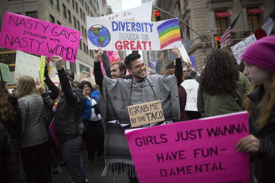 Demonstrators march up 5th Avenue during a women's march, Saturday, Jan. 21, 2017, in New York. The march is being held in solidarity with similar events taking place in Washington and around the nation. (AP Photo/Mary Altaffer)