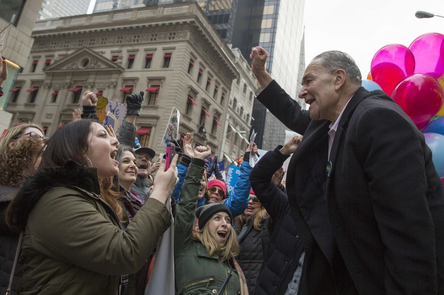 Senate Minority Leader Charles Schumer of N.Y, joins demonstrators marching up 5th Avenue during a women's march, Saturday, Jan. 21, 2017, in New York. The march is being held in solidarity with similar events taking place in Washington and around the nation. (AP Photo/Mary Altaffer)