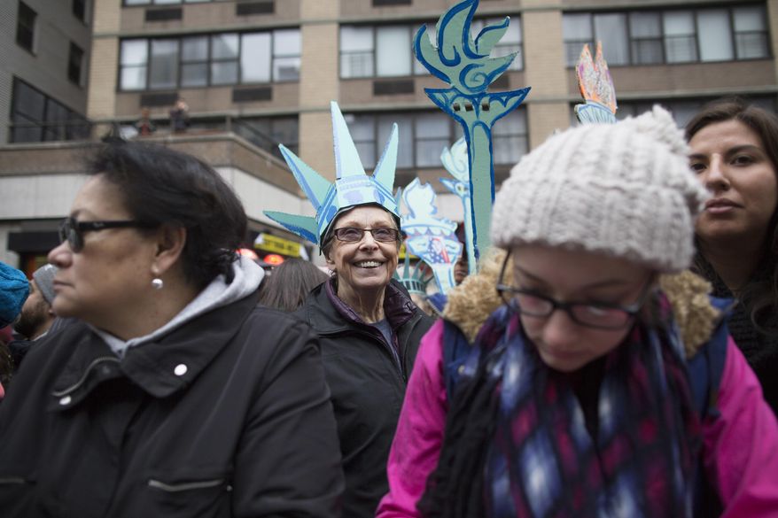 Demonstrators participate in a women's march in New York, Saturday, Jan. 21, 2017. The march is being held in solidarity with similar events taking place in Washington and around the nation. (AP Photo/Mary Altaffer)