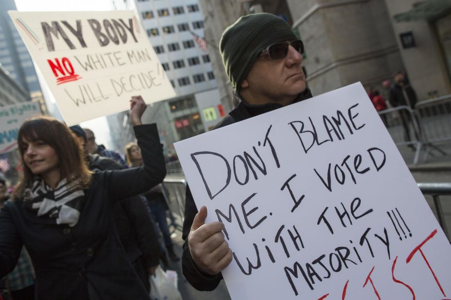 Demonstrators march up 5th Avenue during a women's march, Saturday, Jan. 21, 2017, in New York. The march is being held in solidarity with similar events taking place in Washington and around the nation. (AP Photo/Mary Altaffer)