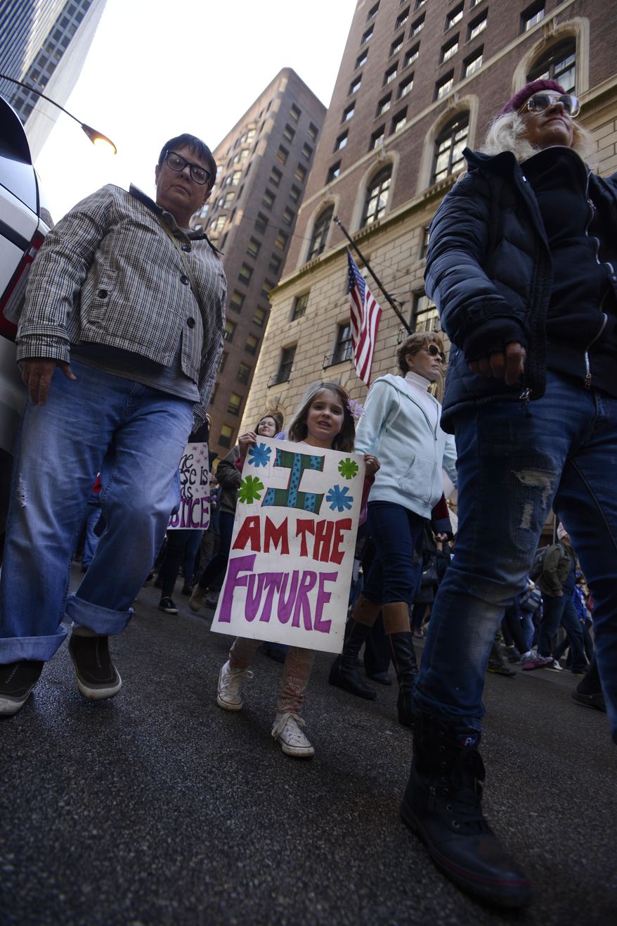 Protesters protest newly inaugurated President Donald Trump during a women's march Saturday, Jan. 21, 2017, in Chicago. (AP Photo/Paul Beaty)