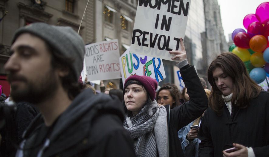 Demonstrators march up 5th Avenue during a women&#39;s march, Saturday, Jan. 21, 2017, in New York. The march is being held in solidarity with similar events taking place in Washington and around the nation. (AP Photo/Mary Altaffer)