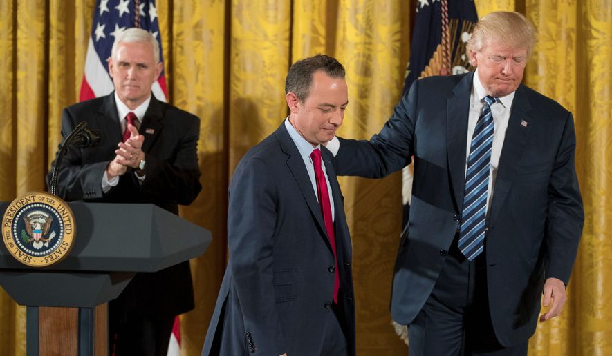 President Trump leads Chief of Staff Reince Priebus off the stage on Sunday after a swearing-in ceremony for 30 senior staff members. With Vice President Mike Pence (left), he gave a pep talk to &quot;prove worthy of this moment in history.&quot; (Associated Press)