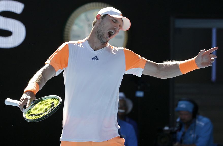 Germany's Mischa Zverev raises his arms while playing Britain's Andy Murray during their fourth round match at the Australian Open tennis championships in Melbourne, Australia, Sunday, Jan. 22, 2017. (AP Photo/Aaron Favila)