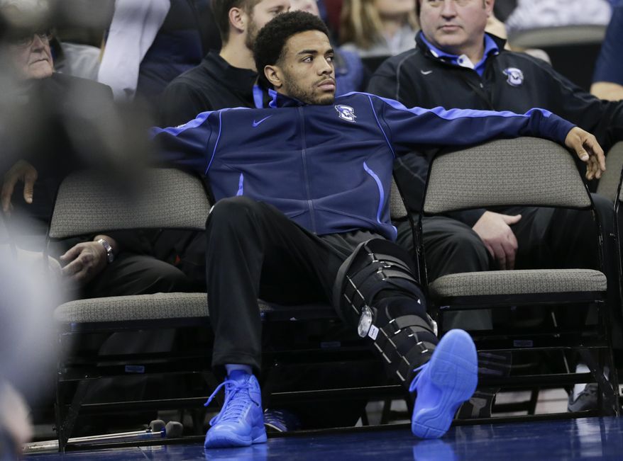 Creighton&#39;s Maurice Watson Jr., out for the season due to a torn ACL, sits on the bench during the second half of an NCAA college basketball game against Marquette in Omaha, Neb., Saturday, Jan. 21, 2017. Marquette won 102-94. (AP Photo/Nati Harnik)