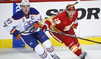 Edmonton Oilers&#39; Connor McDavid, left, tangles with Calgary Flames&#39; Matt Stajan during the second period of an NHL hockey game Saturday, Jan. 21, 2017, in Calgary, Alberta. (Jeff McIntosh/The Canadian Press via AP)