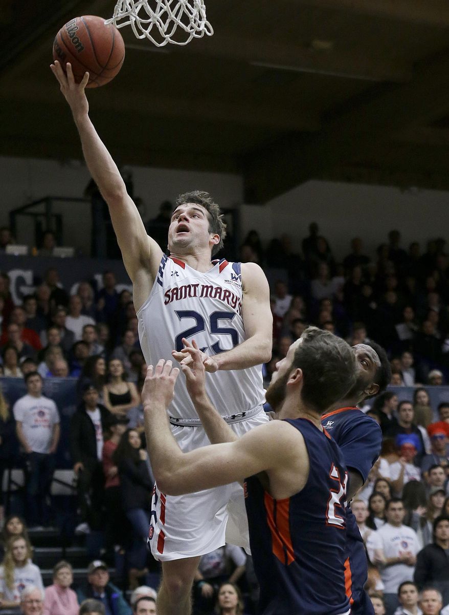 Saint Mary's guard Joe Rahon (25) shoots over Pepperdine guard Knox Hellums during the first half of an NCAA college basketball game in Moraga, Calif., Saturday, Jan. 21, 2017. (AP Photo/Jeff Chiu)