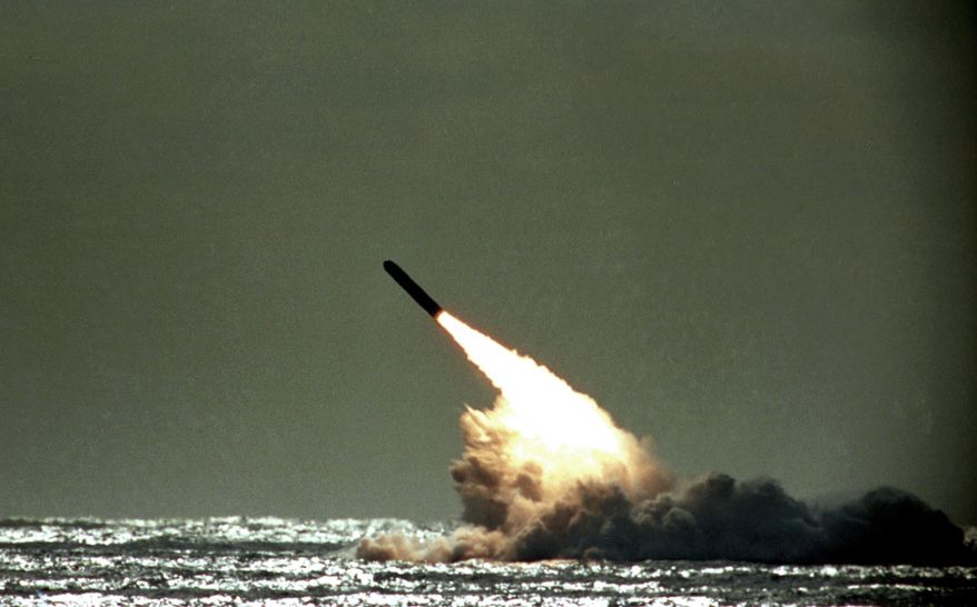 FILE - In this file photo dated Monday, Dec. 4, 1989, a Trident II missile launched by the U.S. Navy during a performance evaluation from the submerged submarine USS Tennessee in the Atlantic Ocean off the coast of Cape Canaveral in Titusville, Fla., USA. According to Britain's Sunday Times newspaper published Sunday Jan. 22, 2017, an unarmed nuclear test missile fired by a British submarine off the coast of Florida in 2016, misfired and the failure was allegedly covered up ahead of a debate in Parliament on the future of the Trident missile system. British Prime Minister Theresa May has refused to say whether she knew about the reported failure. (AP Photo/Phil Sandlin, FILE)