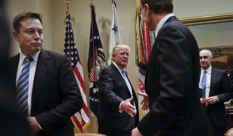 President Donald Trump greets Wendell P. Weeks, right, Chief Executive Officer of Corning, as he host breakfast with business leaders in the Roosevelt Room of the White House in Washington, Monday, Jan. 23, 2017. On the left of is Elon Musk, CEO of SpaceX and Tesla Motors. (AP Photo/Pablo Martinez Monsivais)