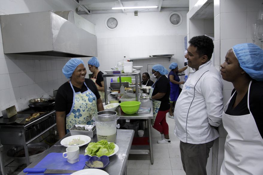 This Jan. 13, 2017 photo show inmates who cook for the Interno restaurant in the kitchen at the San Diego prison, in Cartagena, Colombia. Convicts have been serving up gourmet meals at the Interno in the all-women prison since December, in a novel experiment intended to promote the inmates’ rehabilitation and confront the Colombian public’s neglect of the country’s exploding prison population. (AP Photo/Alba Tobella)