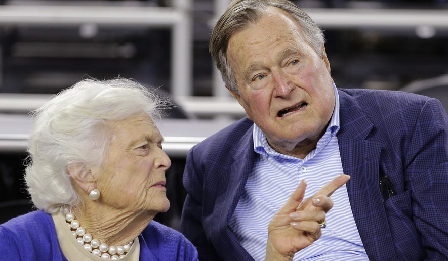 In this March 29, 2015, file photo, former President George H.W. Bush and his wife, Barbara Bush, speak at a college basketball game in Houston. (AP Photo/David J. Phillip, File)
