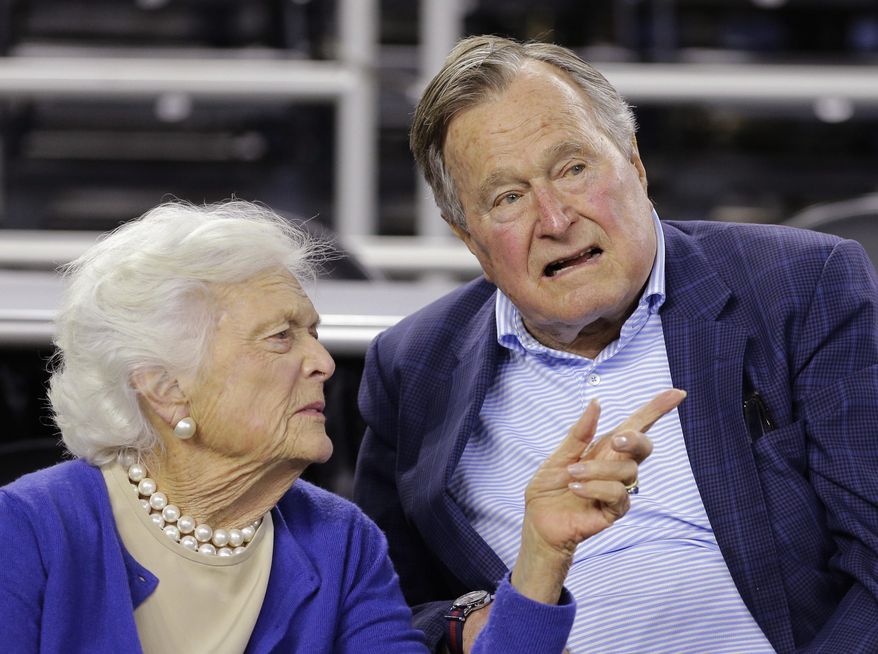 In this March 29, 2015, file photo, former President George H.W. Bush and his wife, Barbara Bush, speak at a college basketball game in Houston. (AP Photo/David J. Phillip, File)