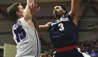 Gonzaga forward Johnathan Williams puts up a shot on Portland center Philipp Hartwich during the second half of an NCAA college basketball game in Portland, Ore., Monday, Jan. 23, 2017. Gonzaga won 83-64. (AP Photo/Steve Dykes)