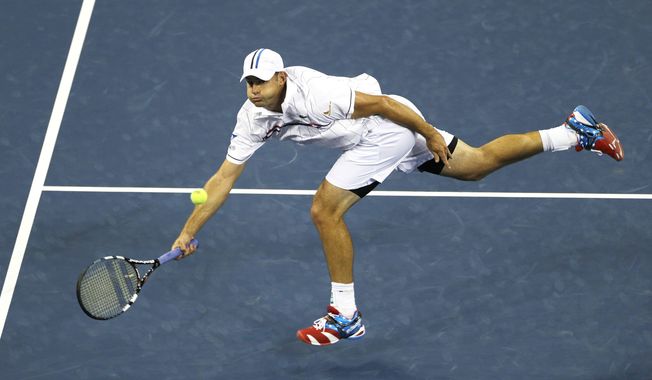 FILE - In this Aug. 31, 2012, file photo, Andy Roddick returns a shot to Australia&#x27;s Bernard Tomic in the third round of play at the 2012 US Open tennis tournament in New York. Roddick and Kim Clijsters have been elected to the International Tennis Hall of Fame. (AP Photo/Mike Groll, File)