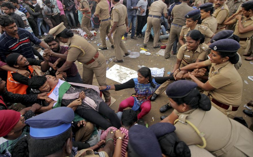 Protestors supporting Jallikattu, a traditional bull-taming ritual try to hold on to each other as police remove them from the Marina beach on the Bay of Bengal coast in Chennai, India, Monday, Jan.23, 2017. Protestors attacked a police station with stones and set some vehicles on fire Monday in anger at being forcibly evicted from the beach where they been protesting for the past week in support of the sport. Jallikattu involves releasing a bull into a crowd of people who attempt to grab it and ride it. It is popular in Tamil Nadu state, but India&#39;s top court banned it in 2014 on grounds of animal cruelty. (AP Photo)