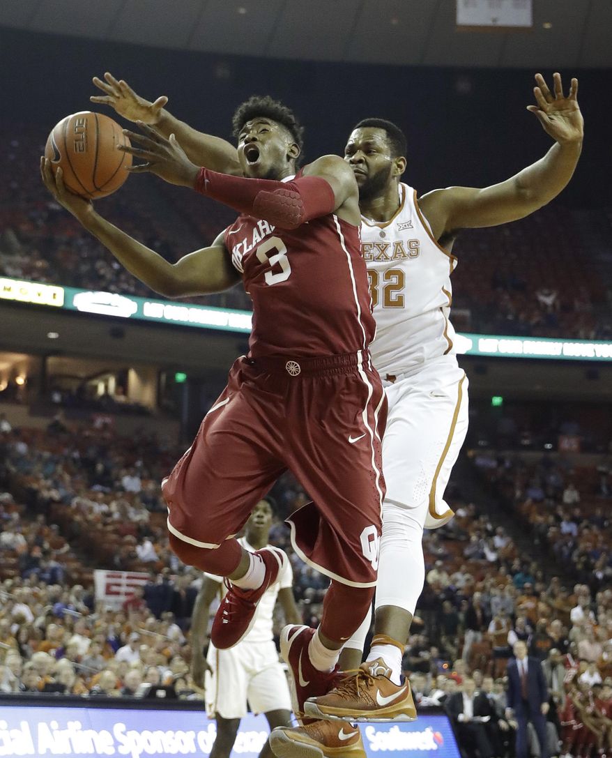 Oklahoma guard Christian James (3) is fouled by Texas forward Shaquille Cleare (32) as he drives to the basket during the first half of an NCAA college basketball game, Monday, Jan. 23, 2017, in Austin, Texas. (AP Photo/Eric Gay)