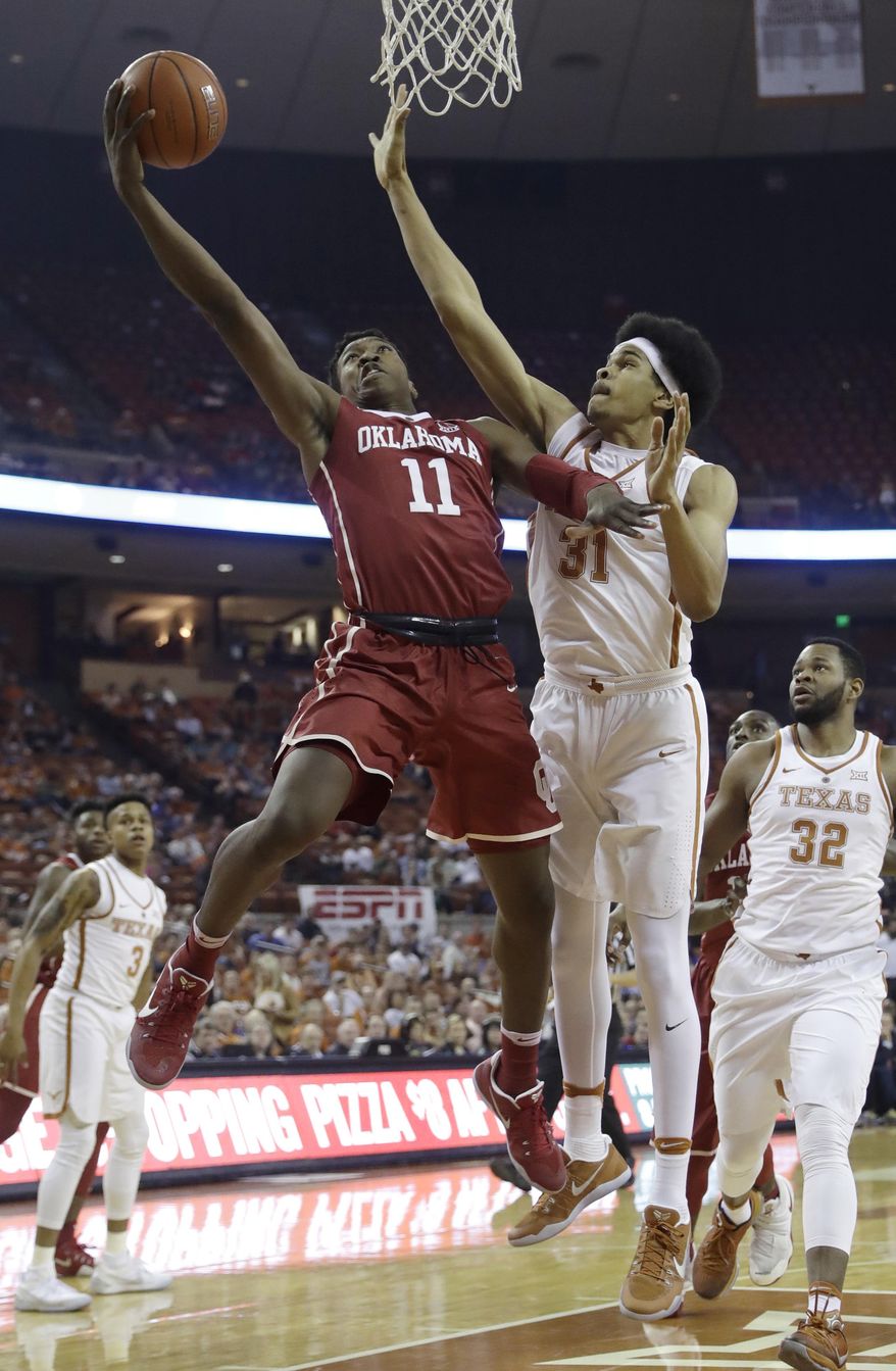 Oklahoma forward Kristian Doolittle (11) shoots past Texas forward Jarrett Allen (31) during the first half of an NCAA college basketball game, Monday, Jan. 23, 2017, in Austin, Texas. (AP Photo/Eric Gay)