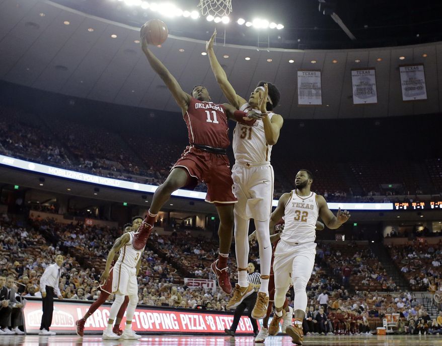 Oklahoma forward Kristian Doolittle (11) shoots past Texas forward Jarrett Allen (31) during the first half of an NCAA college basketball game, Monday, Jan. 23, 2017, in Austin, Texas. (AP Photo/Eric Gay)
