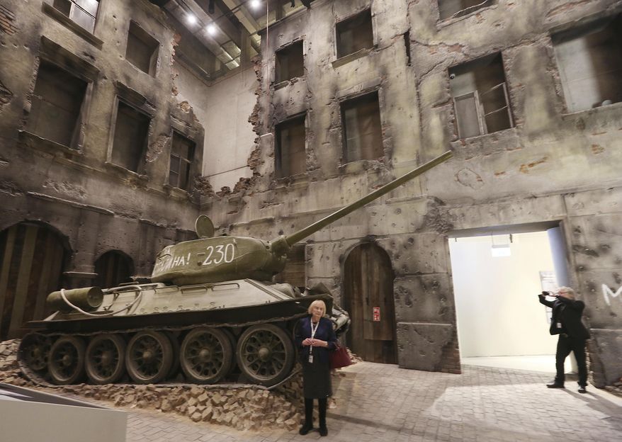 A woman stands in front of an exhibit in the Museum of the Second World War, an ambitious new museum under creation for nine years has opened its doors for a day to historians, museums and reporters in Gdansk, Poland, on Monday, Jan. 23, 2017. (AP Photo/Czarek Sokolowski)
