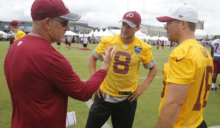 FILE - In this July 29, 2016, file photo, Washington Redskins quarterback coach Matt Cavanaugh, left, talks with Redskins quarterbacks Kirk Cousins (8) and Colt McCoy, right, at the NFL football team&#39;s training camp in Richmond, Va. The Washington Redskins promoted Cavanaugh to offensive coordinator and Greg Manusky to defensive coordinator.  (AP Photo/Steve Helber, File)