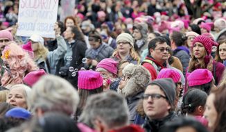Emily Phonelath blows bubbles while in the crowd of the Women&#x27;s March on Washington in Washington, D.C., on Saturday, Jan. 21, 2017. (Aileen Devlin/The Daily Press via AP) ** FILE **