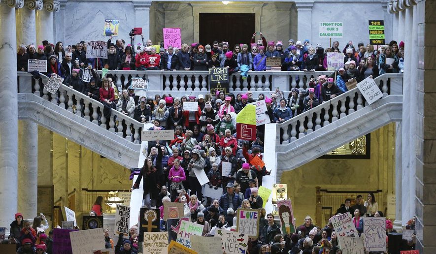 Thousands of people attend a women's march and rally on the Capitol in Salt Lake City, Monday, Jan. 23, 2017. The demonstrators in Salt Lake City hiked a steep hill in heavy snow and wind Monday afternoon before pouring into the capitol, packing its three main floors, hallways and staircases amid speeches and chants from activists and a few Democratic lawmakers. (Scott G Winterton/The Deseret News via AP)