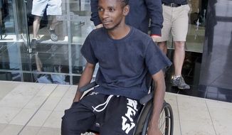 FILE - In this Aug. 10, 2016, file photo, Abdullahi Mohamed, a teenage Somali refugee who was wounded by police during a fight near a homeless shelter, leaves after his first court appearance on robbery and drug charges in Salt Lake City. Prosecutors released videos Monday, Jan. 23, 2017, of the high-profile police shooting that show an officer firing multiple times from short range at Mohamed who was wounded after refusing to drop a metal stick during the fight. (AP Photo/Rick Bowmer, File)