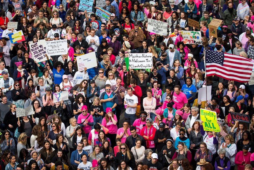 Demonstrators in Dallas and other cities around the world held events Saturday in solidarity with the Women's March on Washington, although members of some groups felt resentment and exclusion. (Associated Press)