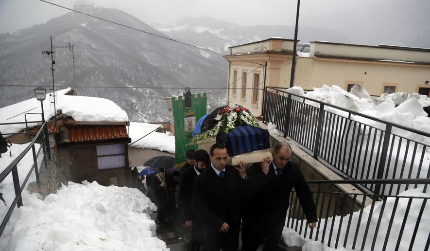 The coffin of Alessandro Giancaterino, one of the victims of the avalanche which buried the Hotel Rigopiano, is shoulder carried prior to the start of the funeral service in Farindola, central Italy,Tuesday, Jan. 24, 2017. The death toll from an avalanche in central Italy climbed to 14 on Tuesday as hopes began to fade that any of the 15 people still missing might be found alive under a mountain resort buried by tons of snow and rubble. (AP Photo/Gregorio Borgia)